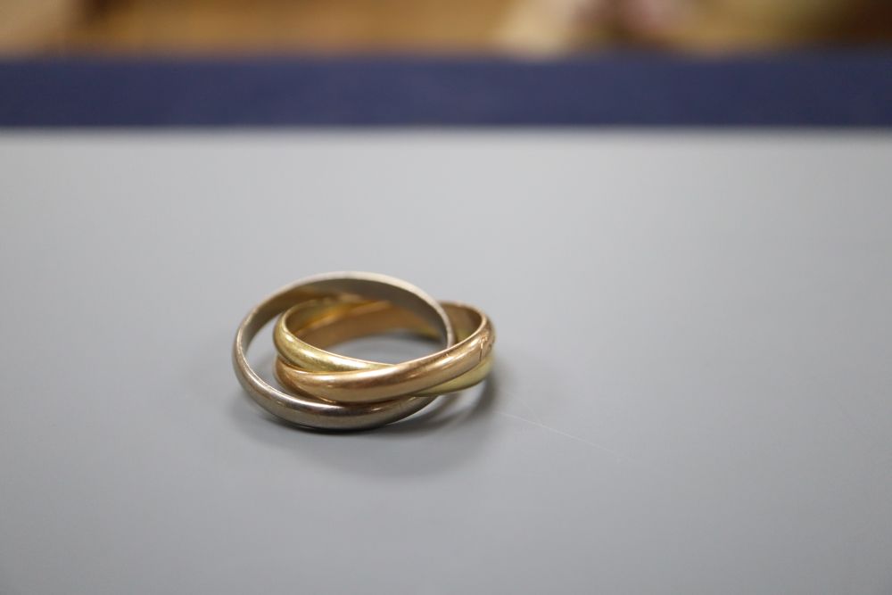 A modern Cartier three colour 750 yellow metal Russian triple band wedding ring, numbered GT527 (on one band only)